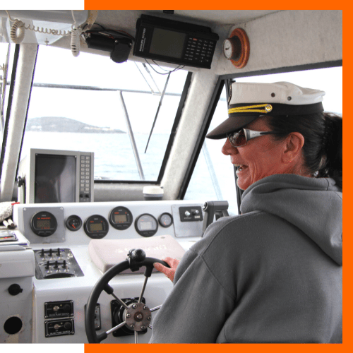 Captain of the day - One of our guests at the helm of the Young Salty Dog